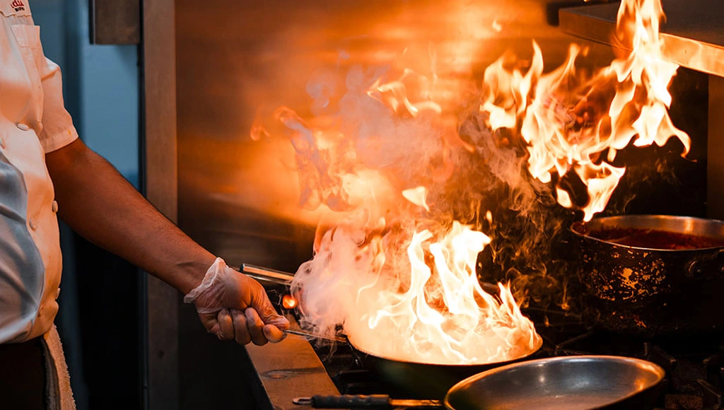 The chef prepares food at Bindia India Bistro, which serves Indian Cuisine in Downtown Toronto.
